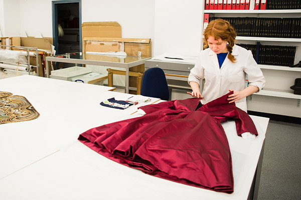 Centre for Textile Conservation - PhD student MPhil student treating a silk satin dress by Christian Dior (1950s)