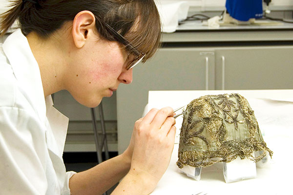 Centre for Textile Conservation - MPhil student conserving a child’s bonnet from the 18th century, from the collections of Glasgow Museums