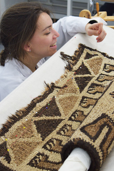 Centre for Textile Conservation - MPhil Textile Conservation student conserving an Ethopian rug